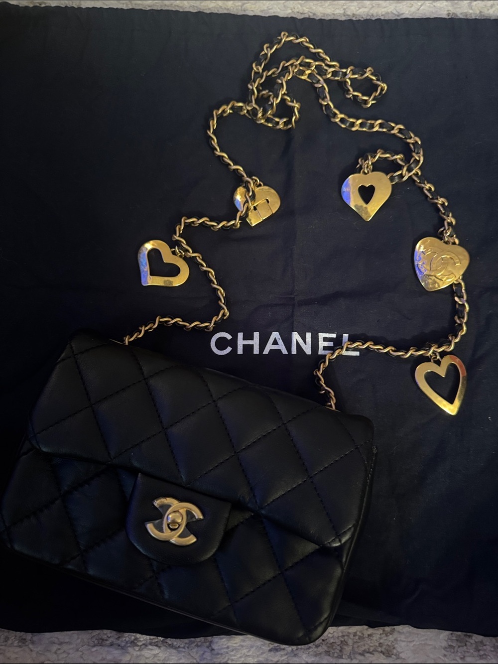 CHANEL Black Lambskin Quilted Mini Crossbody with Heart-Accent Gold Chain